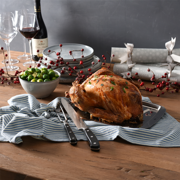 Turkey on a table with crockery and wine